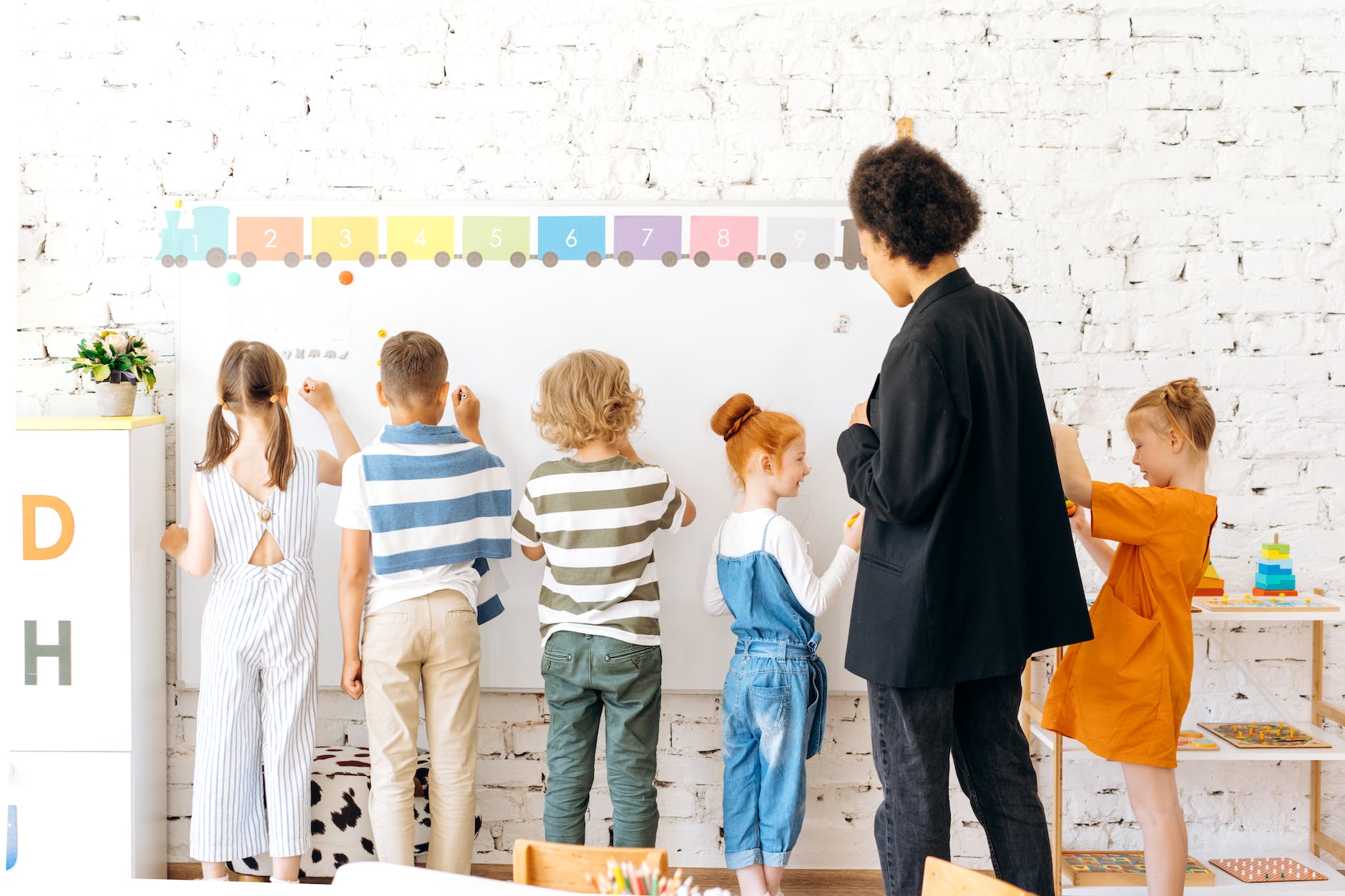 kids writing on a whiteboard