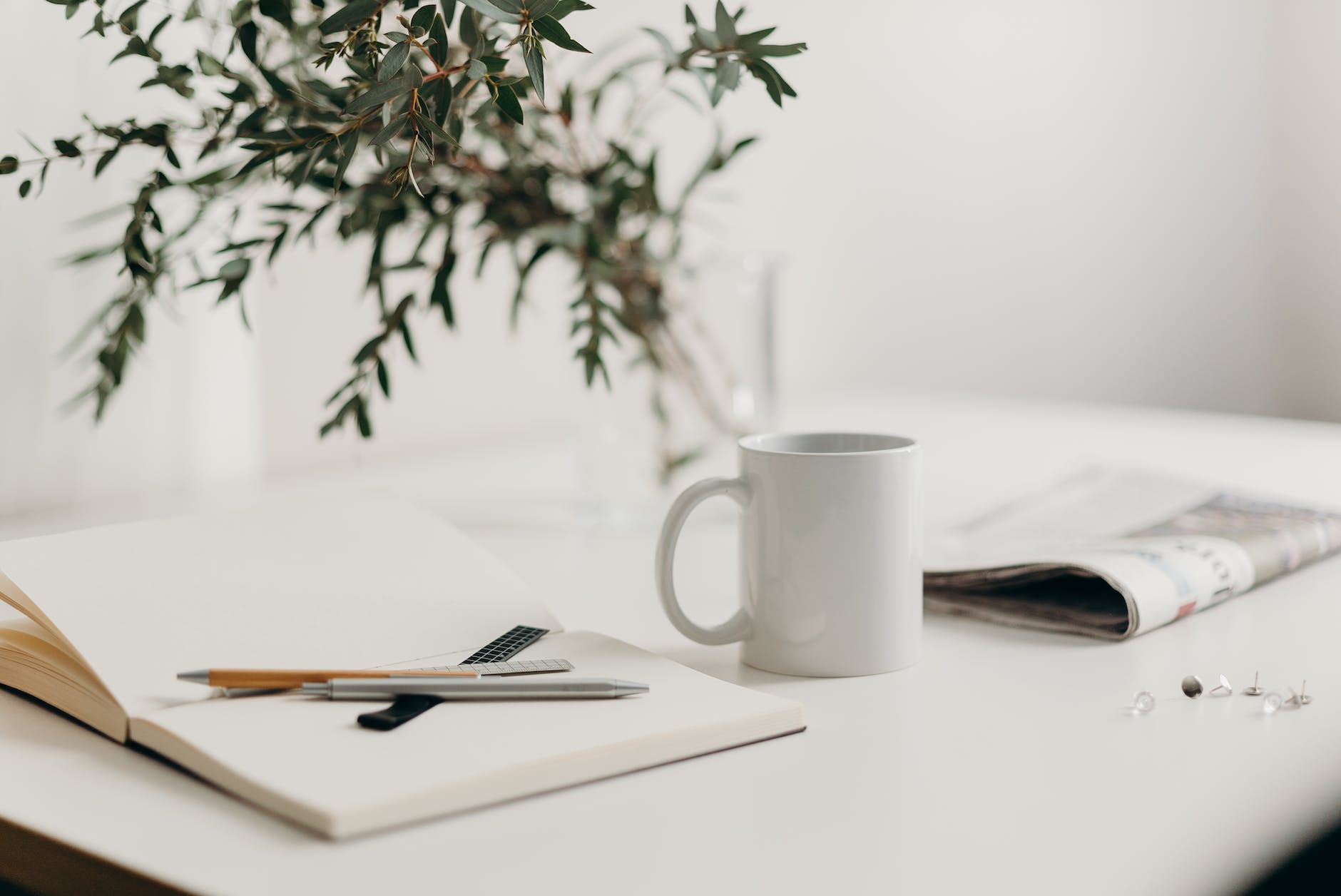 white ceramic mug on white table